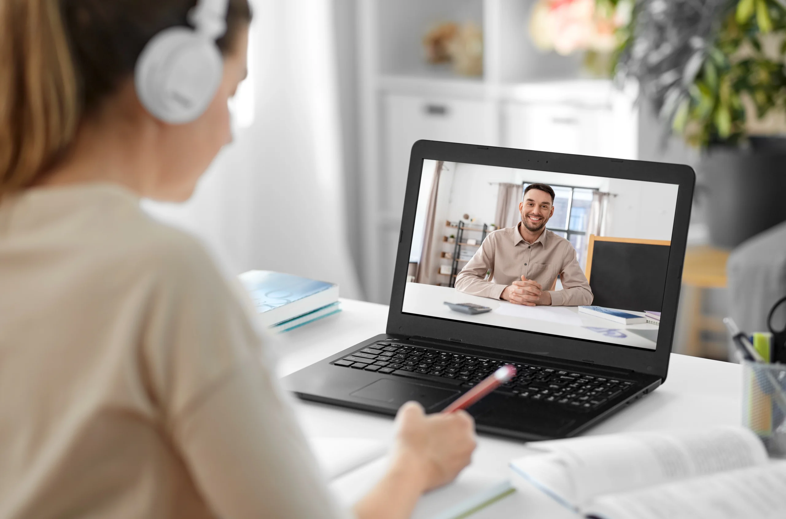 Student with laptop having online counselling session from home